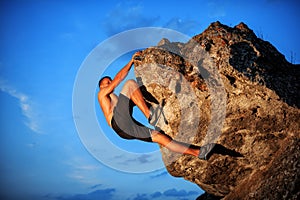 Free climber holding on the cliff