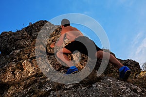 Free climber holding on the cliff