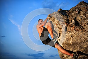 Free climber holding on the cliff