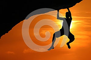 Free climbing on the mountain at red sky sunset background