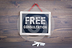Free Consultation. Business success and customer service concept. Chalkboard on a wooden background photo