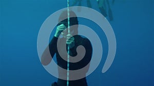 free diver trying to blast ears, defocus to focus. Freediving is a sport when a person dives into sea water while