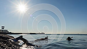 Free diver in wetsuit with flippers ready to dive into the Black sea. Sochi, Russia