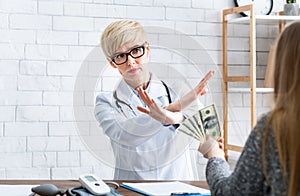 Free doctor consultation. Woman makes gesture with hands, refusal of money