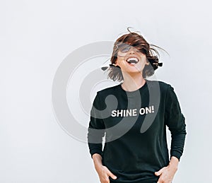 Free feeling happy woman posing in black sweatshirt with positive print Shine On