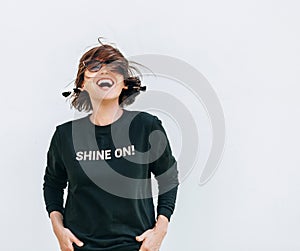 Free feeling happy woman posing in black sweatshirt with positive print Shine On