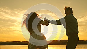 Free guy and girl fooling around in evening in summer park. healthy man and woman play in the bright rays of the sun on