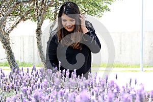 Free, happy, Latin adult woman in harmony and freedom, amid lavender flowers enjoying their beauty and aroma in a moment of relaxa