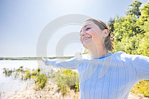 Free Happy Woman Enjoying Nature on a forest lake. Beauty Girl Outdoor. Freedom concept. Beautiful attractive Girl over