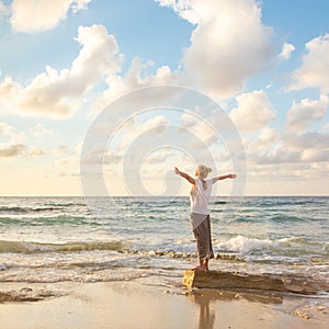 Free Happy Woman Enjoying Sunset on Sandy Beach