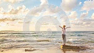 Free Happy Woman Enjoying Sunset on Sandy Beach