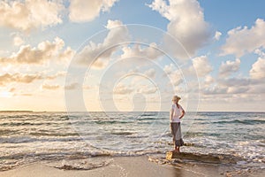 Free Happy Woman Enjoying Sunset on Sandy Beach