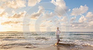 Free Happy Woman Enjoying Sunset on Sandy Beach