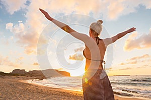 Free Happy Woman Enjoying Sunset on Sandy Beach