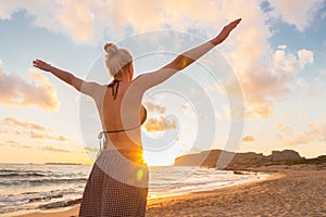 Free Happy Woman Enjoying Sunset on Sandy Beach