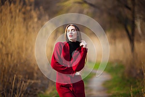 Free happy young woman. Beautiful female with long healthy hair enjoying sun light in park at sunset. Spring, autumn