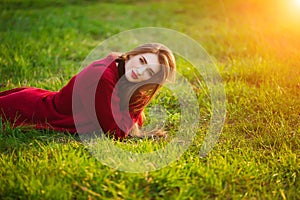 Free happy young woman. Beautiful female with long healthy hair enjoying sun light in park at sunset. Spring, autumn