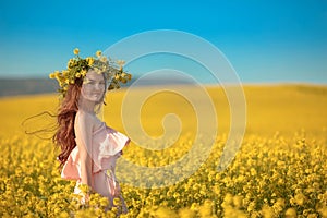 Free happy young woman in field enjoying life. Pretty brune