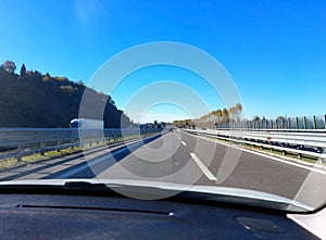 free highway with car dashboard in the foreground during a road trip