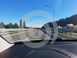 free highway with car dashboard in the foreground during a trip