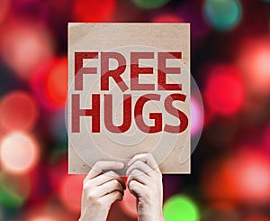 Free Hugs written on colorful background with defocused lights