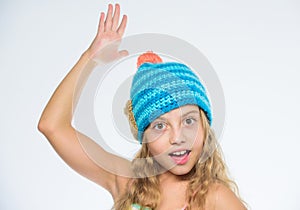 Free knitting patterns. Knitted hat with pompon. Girl long hair happy face white background. Kid wear warm soft knitted