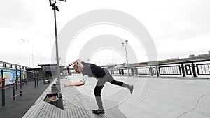 A free run - a tracer blonde man jumps a flip at park, parkour