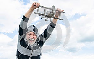 free senior man on sky background. senior man at retirement. senior retired man with toy plane