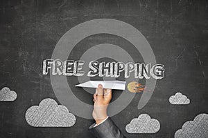 Free shipping concept on blackboard