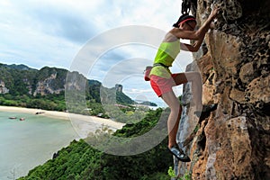 Free solo woman rock climber climbing