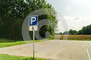 Free space Handicapped parking spot with green trees arround