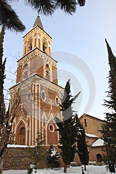 The free-standing three-storey bell-tower in Monastery of St. Nino at Bodbe in winter photo
