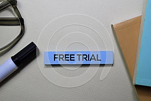 Free Trial text on sticky notes isolated on office desk