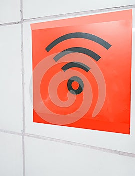 Free Wi-Fi is available in a public area, a sign on the white wall of a modern shopping center building