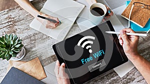 Free wifi connection on device screen. Internet and wireless technology concept.