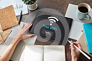 Free wifi connection on device screen. Internet and wireless technology concept.