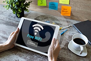 Free wifi connection on device screen. Internet and wireless technology concept.