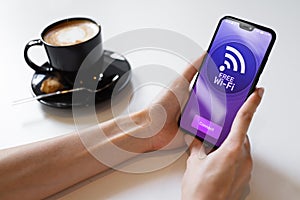 Free wifi connection on mobile phone screen. Internet and telecommunication technology concept.