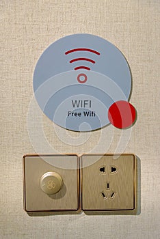 Free WiFi sign and electric outlet set or power sockets on the wall in hotel