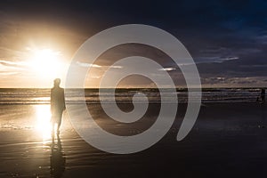 Free woman enjoying freedom feeling happy at beach at sunset. Beautiful serene relaxing woman in pure happiness and