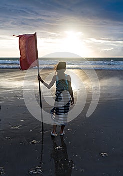 Free woman enjoying freedom feeling happy at beach at sunset. Beautiful serene relaxing woman in pure happiness and
