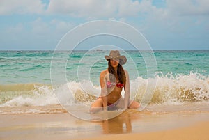 Free woman in hat enjoying freedom feeling happy at beach of sea