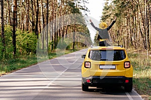 Free Woman Standing out of Car Sunroof Back View