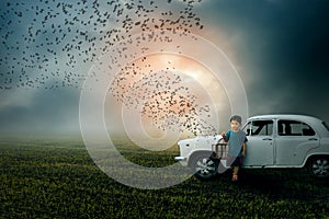 A Free World-Boy child holding bird cage freeing birds