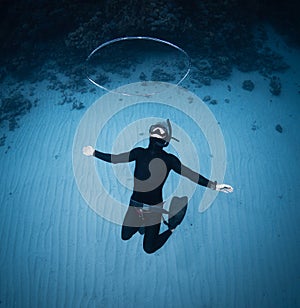 Freediver haves fun and blows the ring bubble