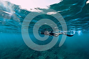 Freediver in wetsuit neoprene swim in the sea