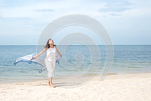 Freedom aisan young women jumping and happy on the suumer beach. Travel and Vacation photo