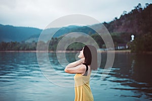 Freedom asian woman standing with hands on head at the sea,Enjoying in Nature,Relaxing ans free concept