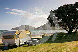 Freedom camping in caravans at an East Coast beach, Gisborne, North Island, New Zealand