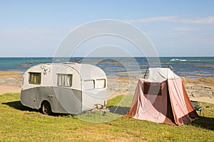 Freedom camping in vintage caravan and tent at an East Coast beach, Gisborne, North Island, New Zealand